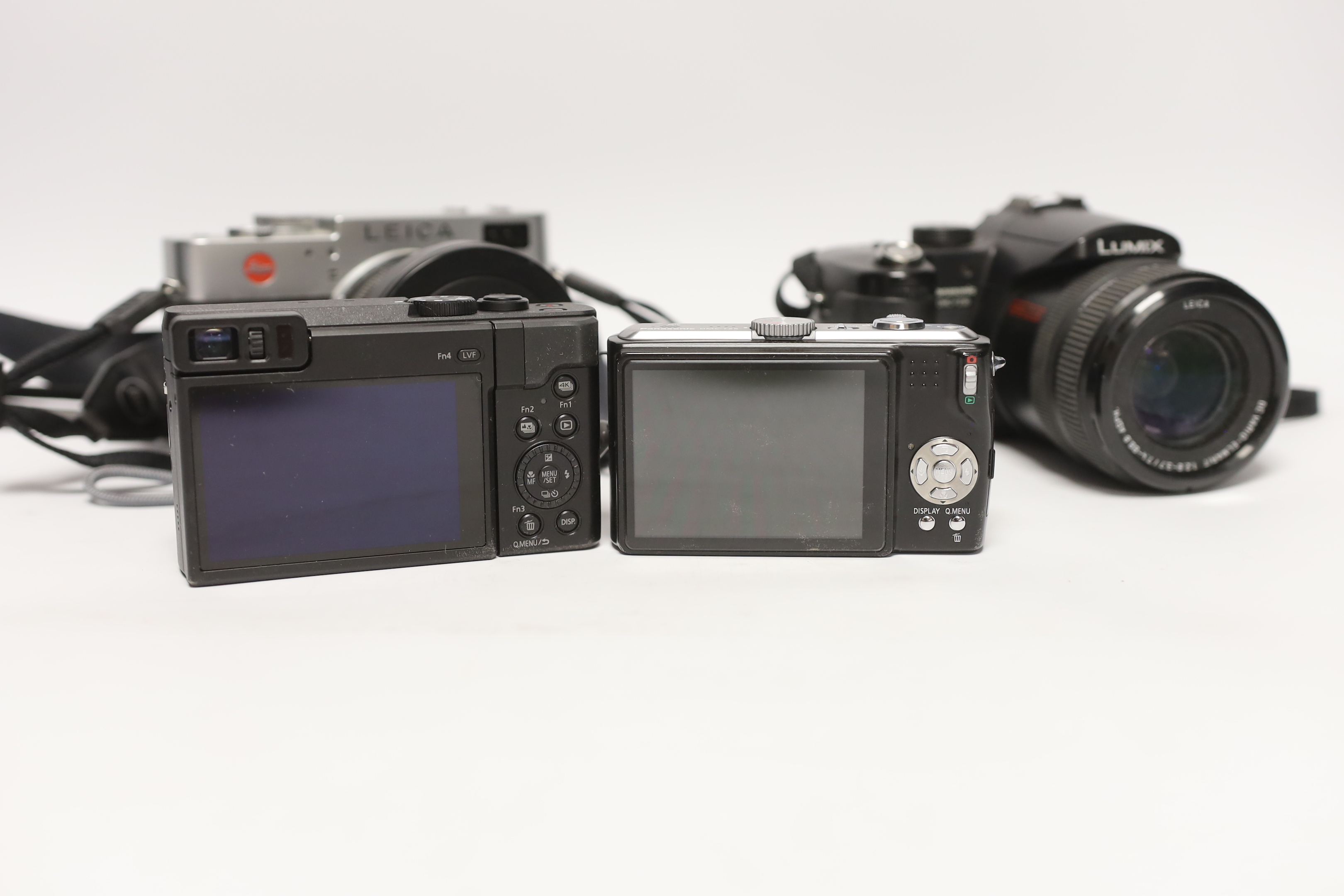 Four digital cameras; a Leica Digilux 2 and three Panasonic Leica models from the LUMIX series